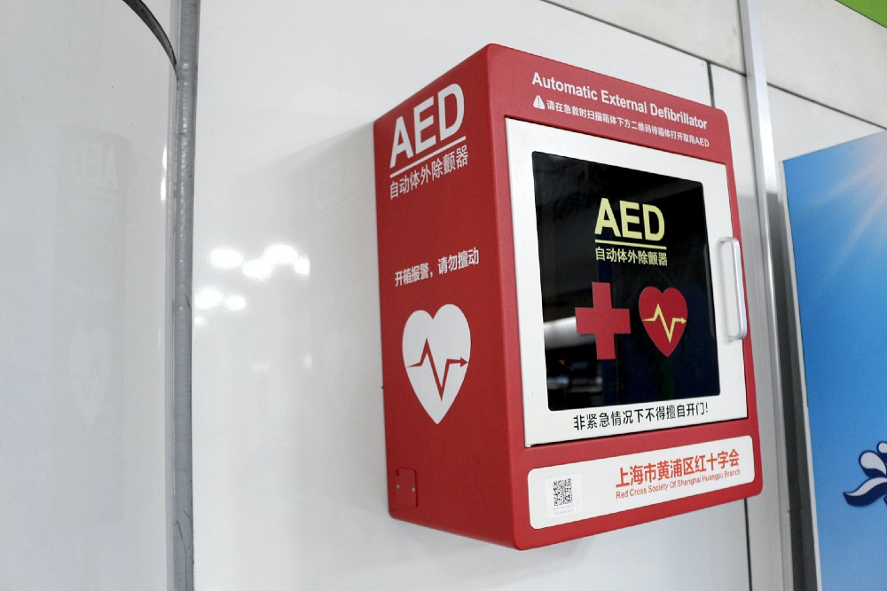 Automated External Defibrillator (AED) in red and white wall cabinet